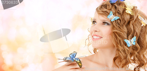 Image of happy teenage girl with butterflies in hair