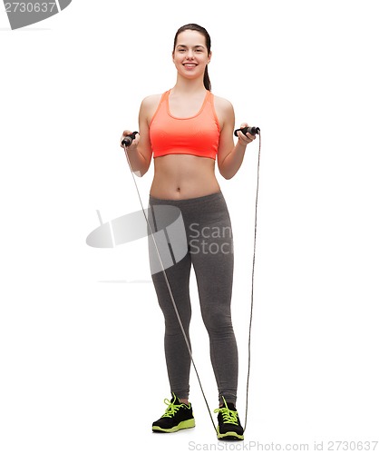 Image of sporty woman with with skipping rope