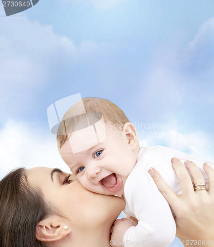 Image of laughing baby playing with mother