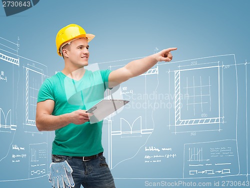 Image of smiling man in helmet with clipboard