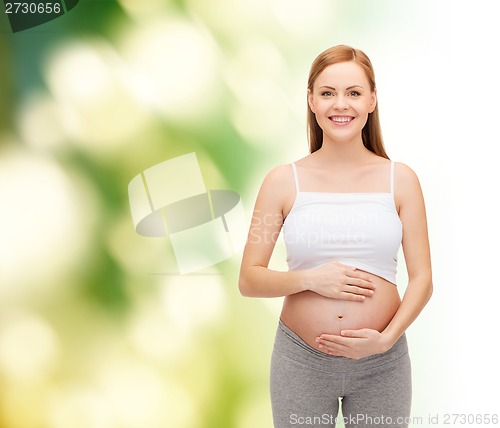 Image of happy future mother touching her belly