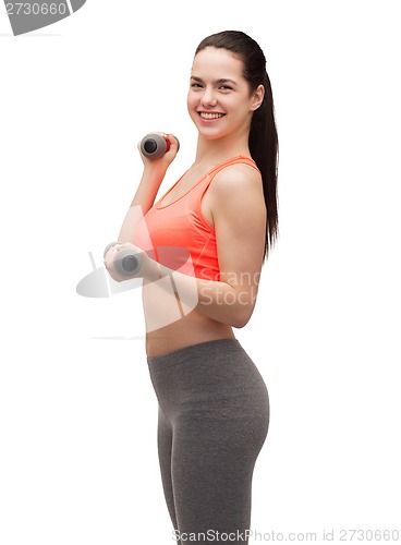 Image of young sporty woman with light dumbbells