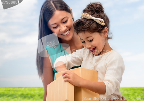 Image of happy mother and child girl with gift box