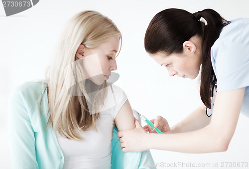 Image of doctor doing vaccine to patient