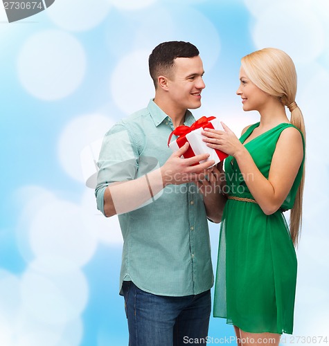 Image of smiling couple with gift box