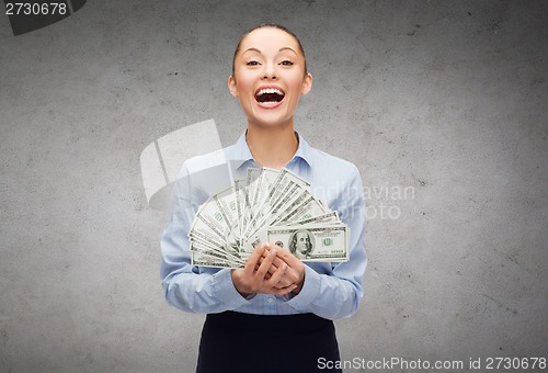 Image of young businesswoman with dollar cash money