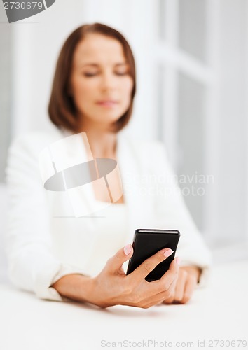 Image of smiling businesswoman or student with smartphone