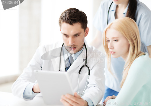 Image of doctor and nurse with patient in hospital