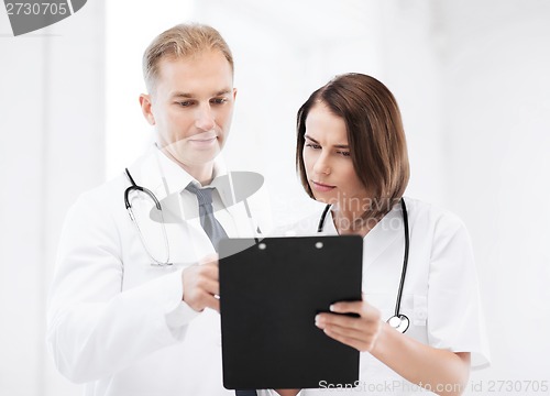 Image of two doctors writing prescription