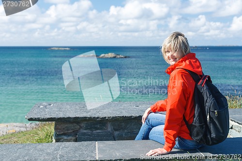 Image of Happy woman enjoying sea / ocean / fjord view