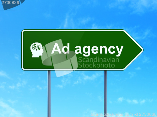 Image of Advertising concept: Ad Agency and Head With Finance Symbol on road sign background