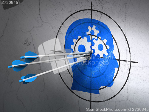 Image of Advertising concept: arrows in Head With Gears target on wall background