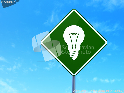 Image of Finance concept: Light Bulb on road sign background