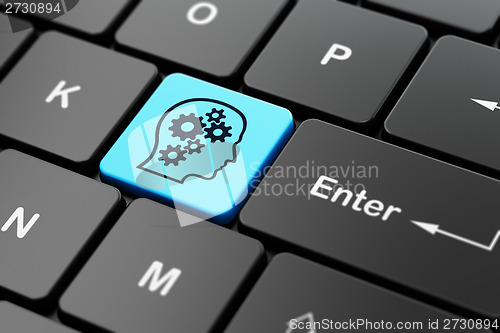 Image of Education concept: Head With Gears on computer keyboard background