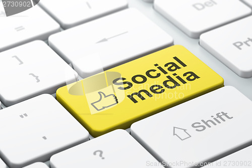 Image of Social network concept: Thumb Up and Social Media on computer keyboard background