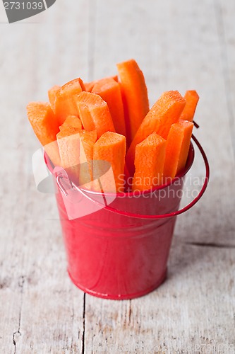 Image of fresh sliced carrot in red bucket 