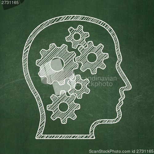 Image of Education concept: Head With Gears on chalkboard background