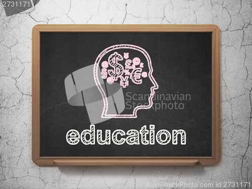 Image of Education concept: Head With Finance Symbol and Education on chalkboard background