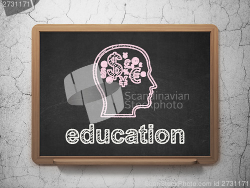 Image of Education concept: Head With Finance Symbol and Education on chalkboard background