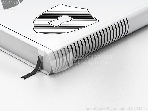 Image of Privacy concept: closed book, Shield With Keyhole on white background