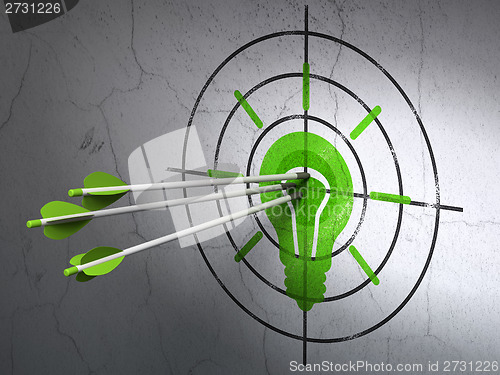 Image of Finance concept: arrows in Light Bulb target on wall background