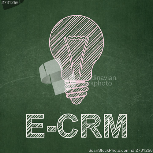 Image of Finance concept: Light Bulb and E-CRM on chalkboard background