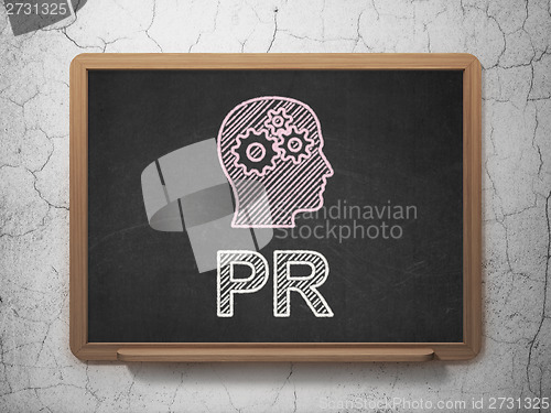 Image of Marketing concept: Head With Gears and PR on chalkboard background