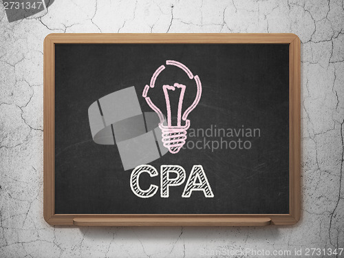 Image of Finance concept: Light Bulb and CPA on chalkboard background