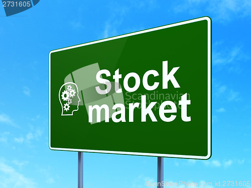 Image of Finance concept: Stock Market and Head With Gears on road sign background
