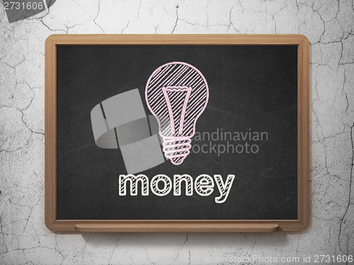 Image of Business concept: Light Bulb and Money on chalkboard background
