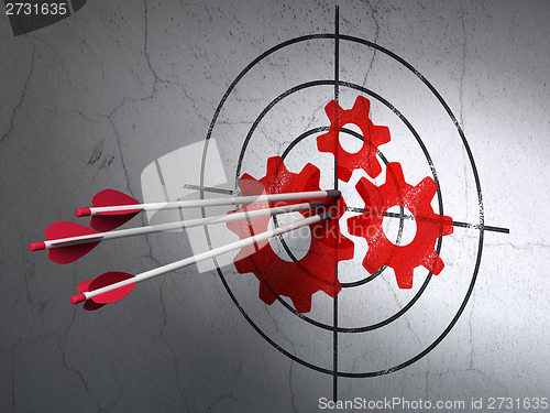 Image of Advertising concept: arrows in Gears target on wall background