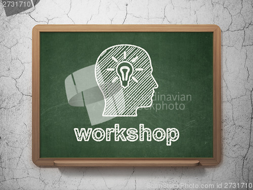 Image of Education concept: Head With Light Bulb and Workshop on chalkboard background