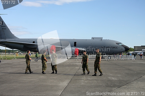 Image of Soldiers in front of a KC-135  transport plane