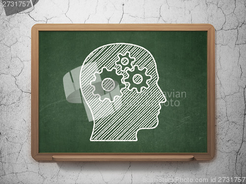 Image of Marketing concept: Head With Gears on chalkboard background