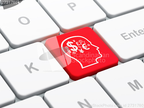 Image of Advertising concept: Head With Finance Symbol on computer keyboard background