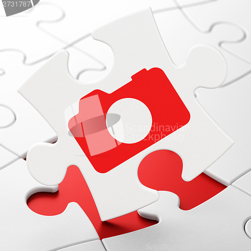 Image of Tourism concept: Photo Camera on puzzle background