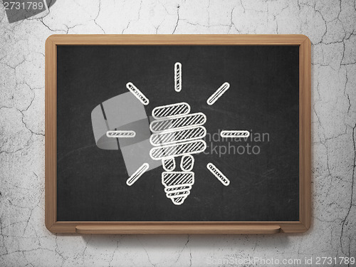 Image of Finance concept: Energy Saving Lamp on chalkboard background