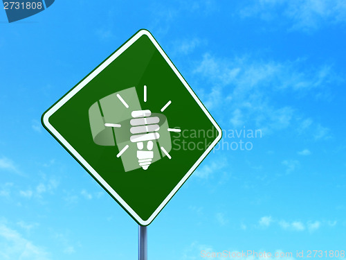 Image of Business concept: Energy Saving Lamp on road sign background