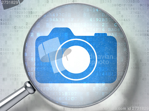 Image of Travel concept: Photo Camera with optical glass on digital background