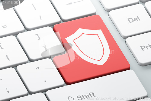 Image of Privacy concept: Shield on computer keyboard background