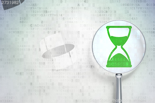 Image of Time concept:  Hourglass with optical glass on digital background