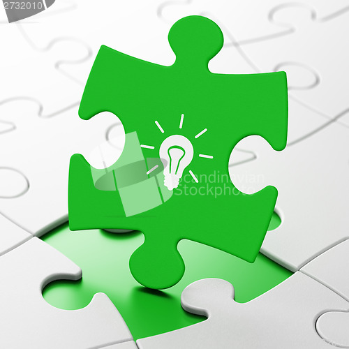 Image of Business concept: Light Bulb on puzzle background