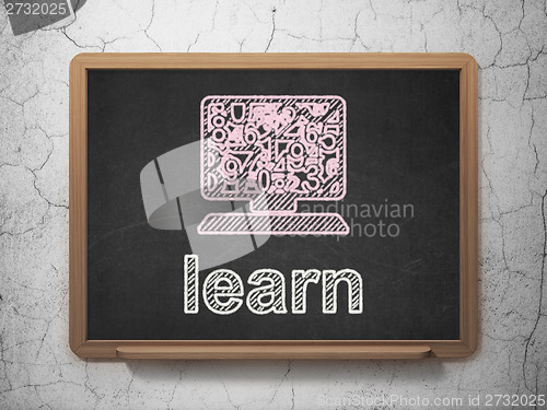 Image of Education concept: Computer Pc and Learn on chalkboard background