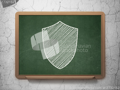 Image of Protection concept: Shield on chalkboard background