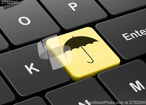 Image of Security concept: Umbrella on computer keyboard background
