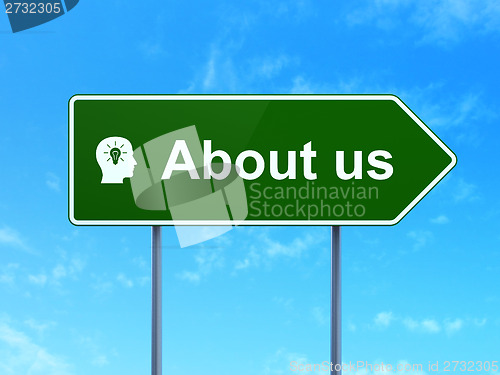 Image of Advertising concept: About Us and Head With Light Bulb on road sign background