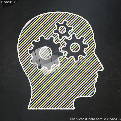 Image of Information concept: Head With Gears on chalkboard background