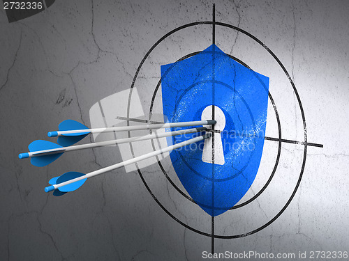 Image of Safety concept: arrows in Shield With Keyhole target on wall background