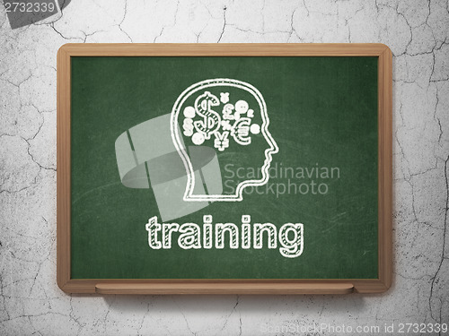 Image of Education concept: Head With Finance Symbol and Training on chalkboard background