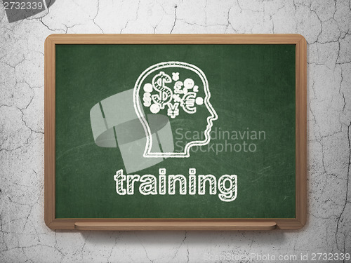 Image of Education concept: Head With Finance Symbol and Training on chalkboard background
